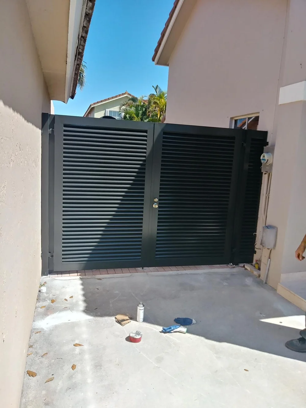 Dark slatted double gate with a clean modern profile