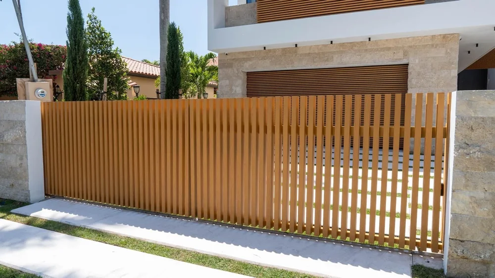 Vertical wood-look gate at a modern white house