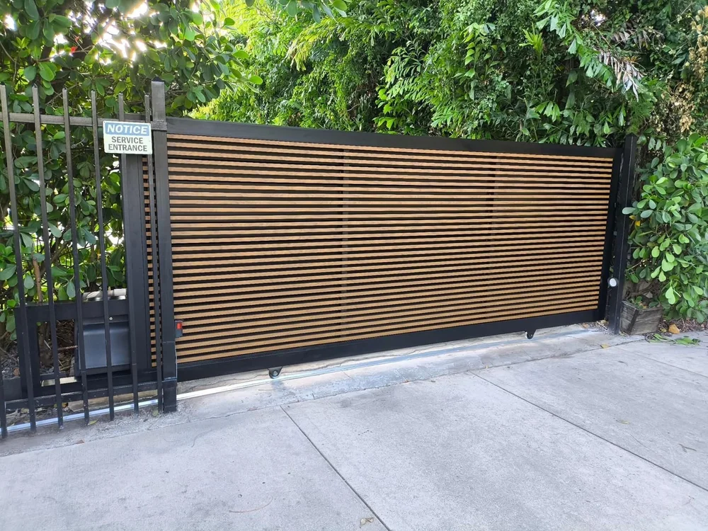 Custom sliding gate with a wood-look finish and black frame